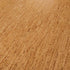 Wicanders Cork Go Whim close-up texture shot of a warm tan cork surface with fine horizontal striations and natural tonal variation.
